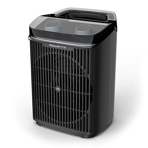 Radiateur soufflant Rowenta noir posé au sol dans une salle de bain claire et contemporaine